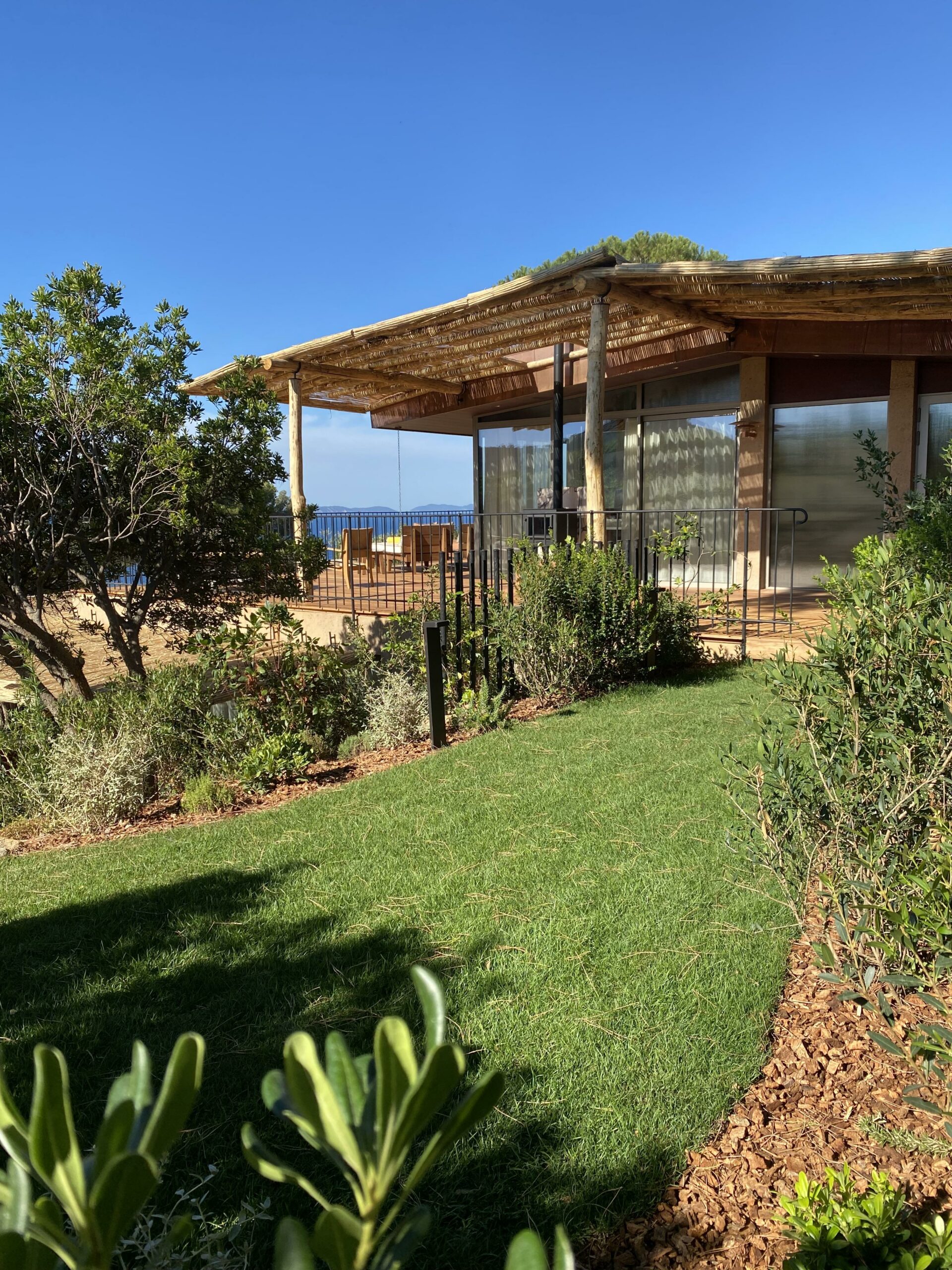 Pool house — toit en canisses face à la mer Pool house au toit de canisses face à la mer dans le jardin d'une villa par MR Paysage